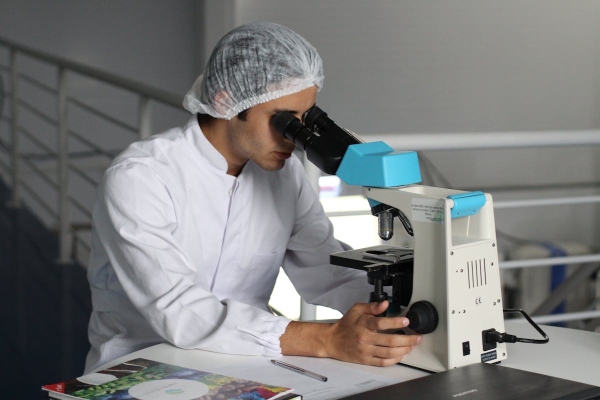 Technician handling sample tubes in a molecular biology lab